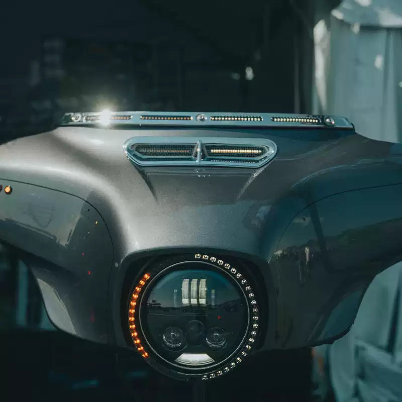 Front view of Harley Touring motorcycle with illuminated windshield trim and headlight