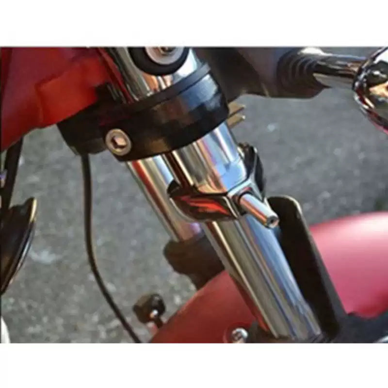 Chrome turn signal relocation bracket installed on a Harley motorcycle front fork