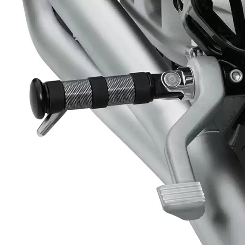 Black cylindrical XL front foot peg installed on a Harley motorcycle