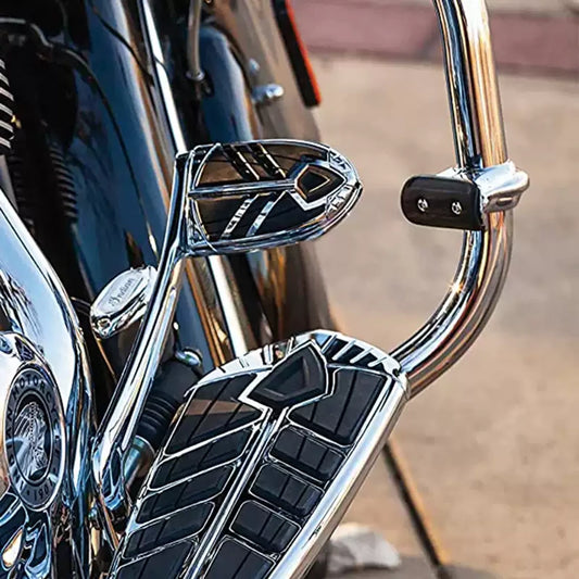 Black highway cruise foot pegs installed on a motorcycle crash bar