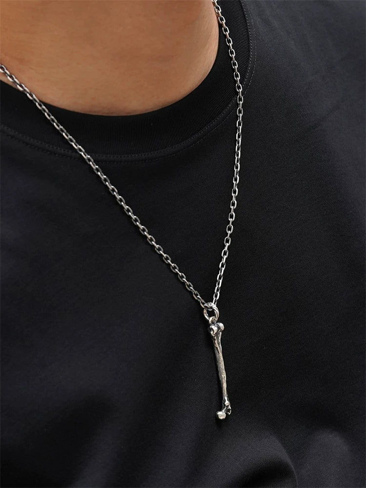 Long bone sterling silver biker pendant worn on a chain