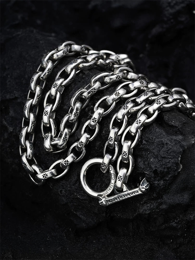 Close-up of engraved links and toggle clasp on sterling silver biker necklace