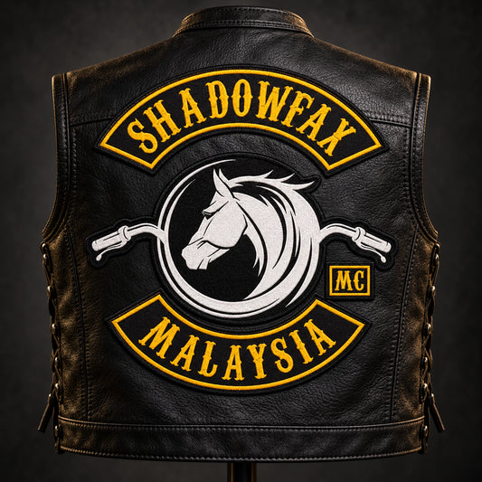 Solid top and bottom rockers around center emblem shown for a custom motorcycle club patch system in workshop vest stand.