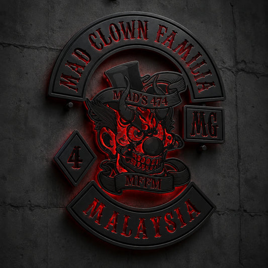 Matte-black motorcycle club metal sign on a dark industrial clubhouse wall.