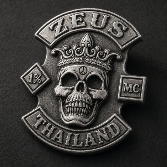 Connected matte silver ZEUS motorcycle club pin with a crowned skull in restrained low-glare sculpted relief.
