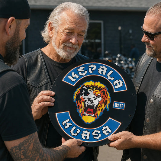 Motorcycle club founder receiving a custom metal recognition sign from chapter members.