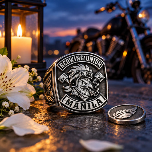 Personalized stainless steel motorcycle club memorial ring displayed with flowers and a candle.