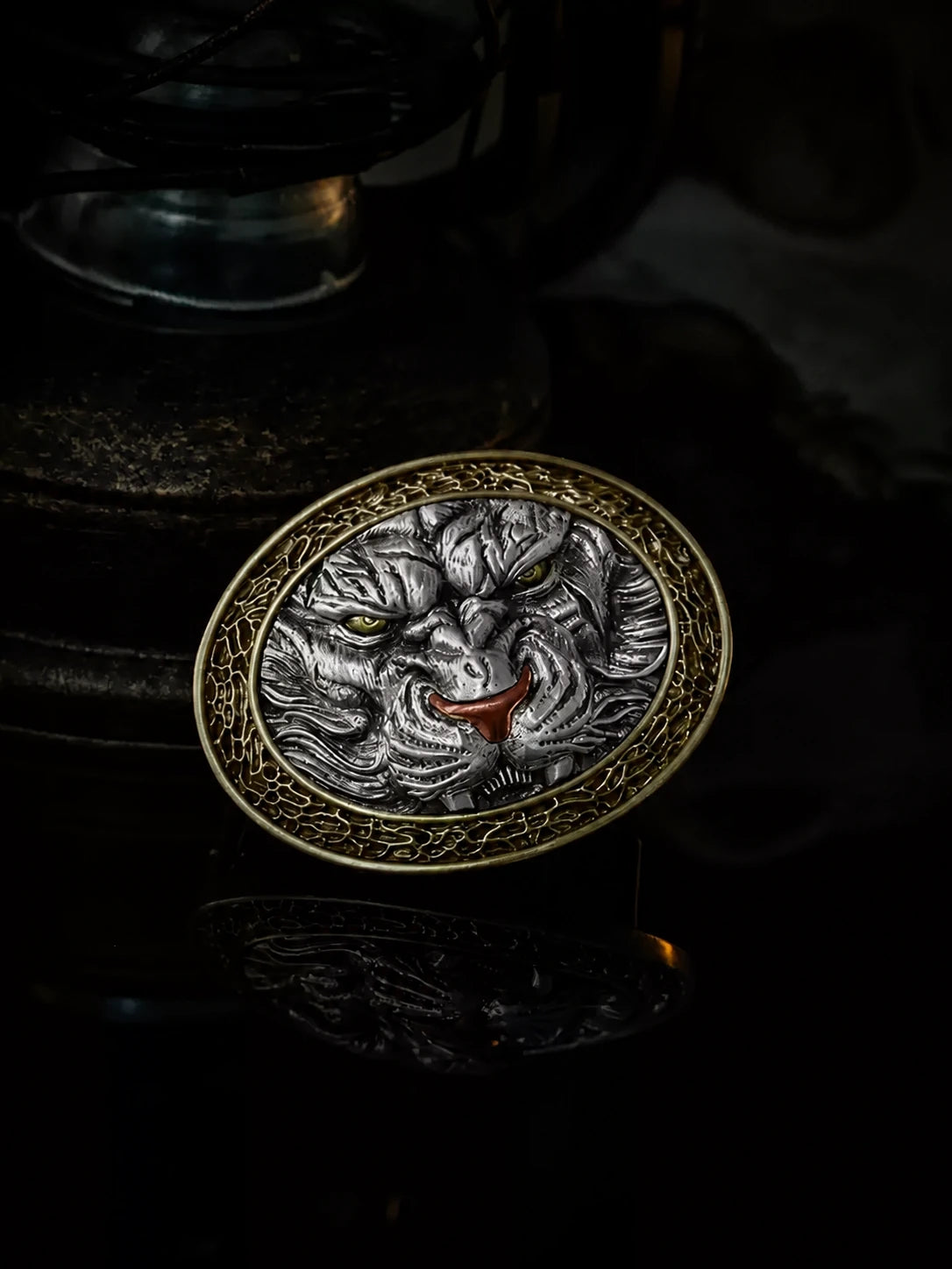 mixed-metal tiger head biker belt buckle on dark studio background