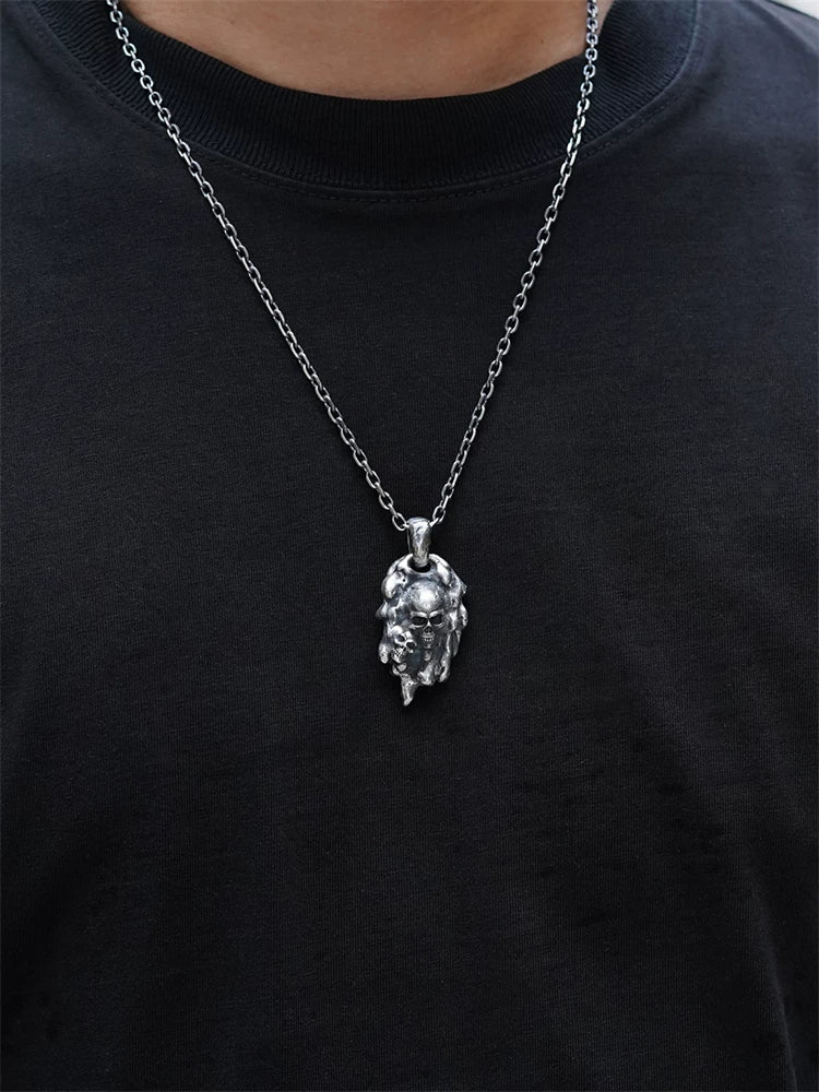 Molten double-skull sterling silver biker pendant worn on chain