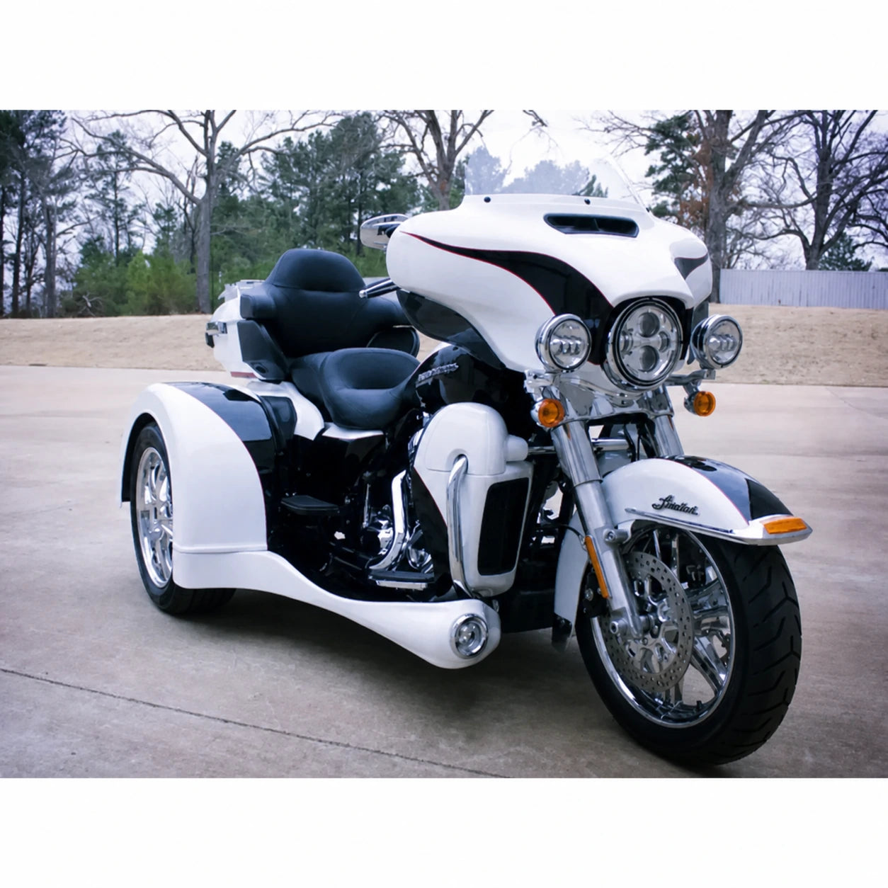 White Harley trike with full-length side body kit installed
