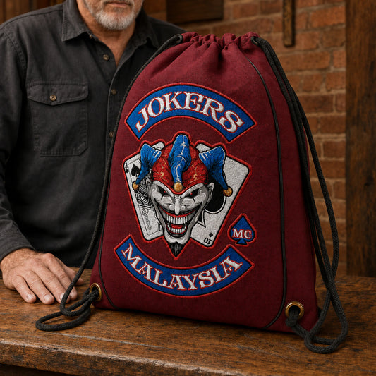 A motorcycle club president presents a limited-edition anniversary drawstring bag at a clubhouse celebration.
