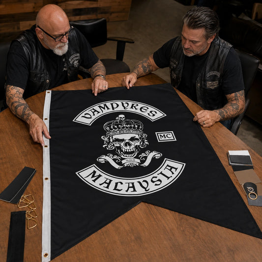 Motorcycle club officers checking artwork, colors and finishing before approving a custom swallowtail flag.