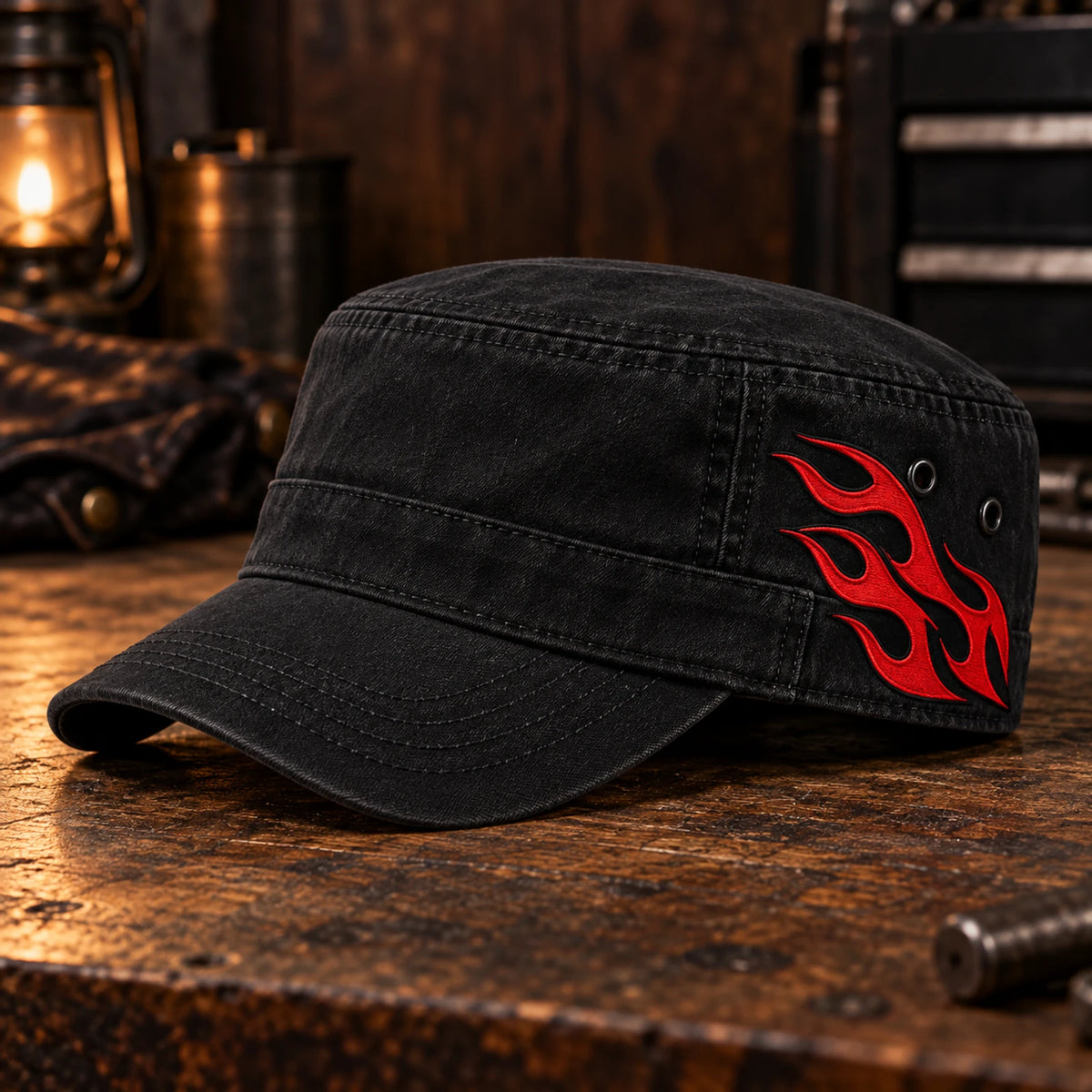 Left-side view of a black military cadet cap with the club's red helmet flame detail.