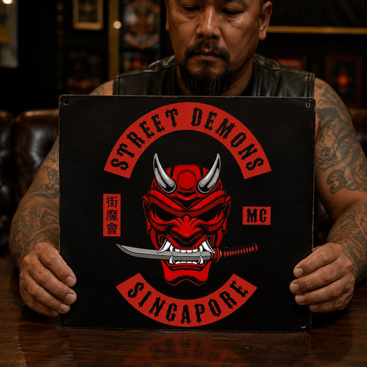 Chapter-specific motorcycle club metal sign displayed in a club meeting room.