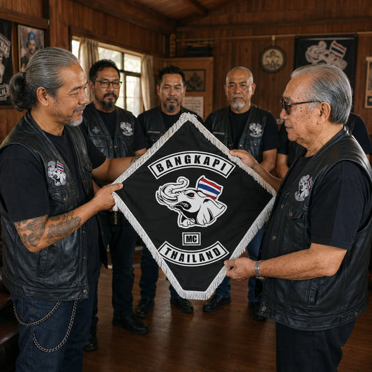 A chapter president presents a custom diamond flag to a veteran motorcycle club member during a clubhouse ceremony.