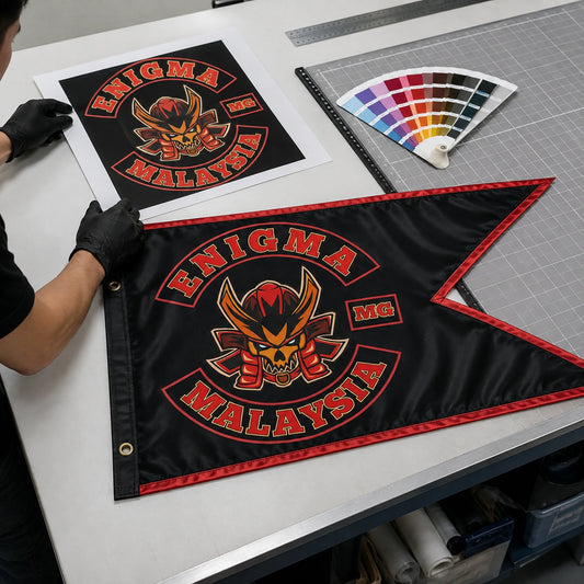 Print technician matching authorized motorcycle club artwork to a custom swallowtail flag.