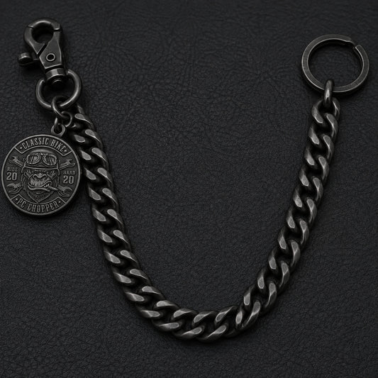 Open black Cuban curb motorcycle club pants chain with a swivel clasp, split wallet ring and side-hung metal club medallion.
