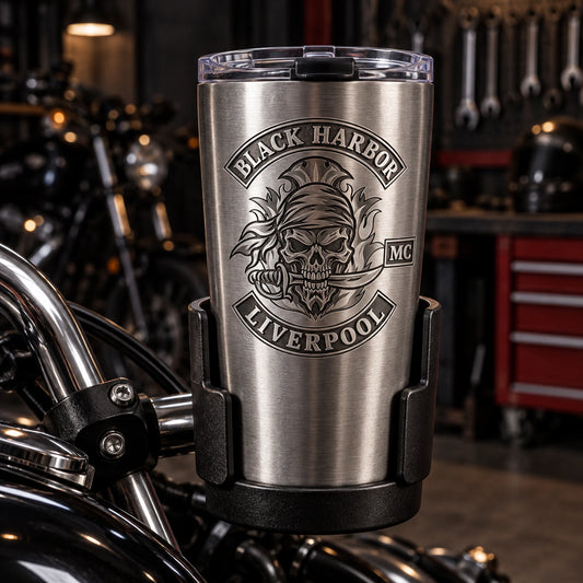 Tapered travel mug beside unbranded motorcycle cup holder displaying an authorized logo for a custom motorcycle club metal mug project.