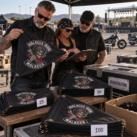 Motorcycle rally volunteers arrange a coordinated order of custom club triangle flags at registration.