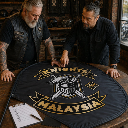 Confirm Final Design: custom motorcycle club feather flag shown in club president and designer carefully reviewing the physical proof together.