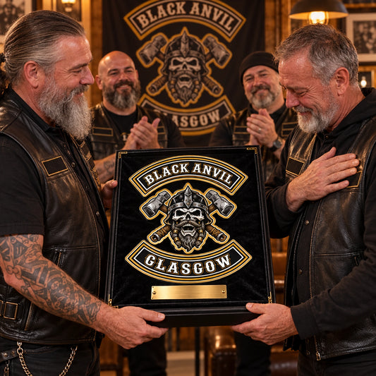 Motorcycle club president presenting a personalized metal sign to a retiring officer during a clubhouse ceremony.
