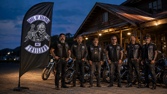 Your Club Identity Deserves To Be Seen: custom motorcycle club feather flag shown in six mature chapter members standing proudly outside a roadside clubhouse at blue hour beside unbranded American V-twin motorcycles.