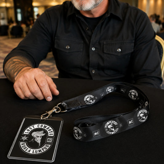 A guest credential set with a club-logo lanyard presented at a rally welcome desk.