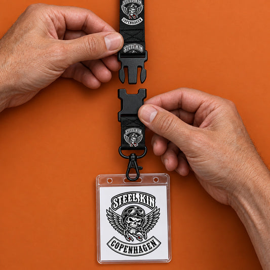 Separated detachable buckle connecting a Steel Kin neck strap to its credential assembly.