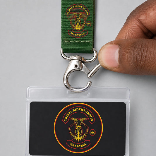 A hand opening the trigger of a lobster hook attached to a nylon motorcycle club lanyard.