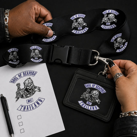 Organizers checking a motorcycle club lanyard, buckle and credential against a printed design proof.