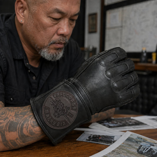 A black motorcycle club glove carries a tonal leather patch with the supplied emblem and its existing location lettering.