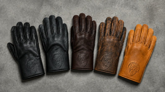 Five black, brown and tan leather motorcycle club glove samples display the same emblem in coordinated tone-on-tone relief.