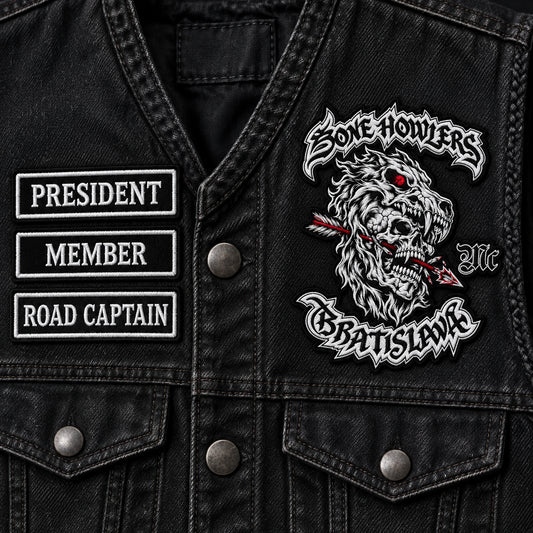 Coordinated member status chest patches with neutral symbols for a motorcycle club, shown at black twill inspection surface.