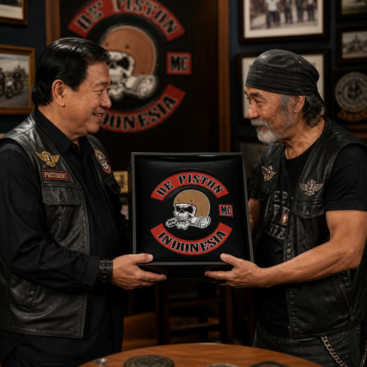 A longtime motorcycle club member receives a custom club-logo cushion as a presentation gift.