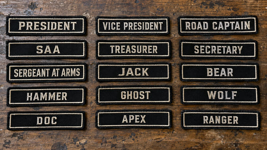 A complete chapter order of many name bars arranged in organized rows, one approved style with different member road names and officer titles, showing custom motorcycle club name bar patch options.