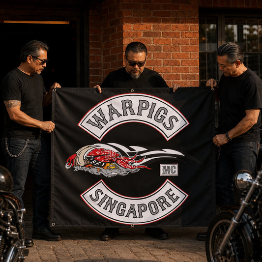 Club members arranging a custom logo banner outside their motorcycle clubhouse.