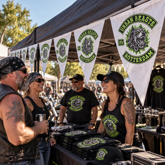 Custom triangle flags identify a motorcycle club booth at a lively late-afternoon rally.