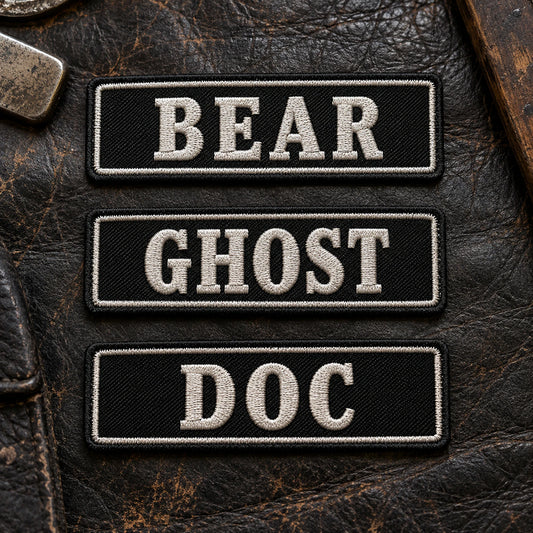 Three premium embroidered road-name bar patches presented on worn black leather, each using the same construction standard but different short road-name wording, showing custom motorcycle club name bar patch options.