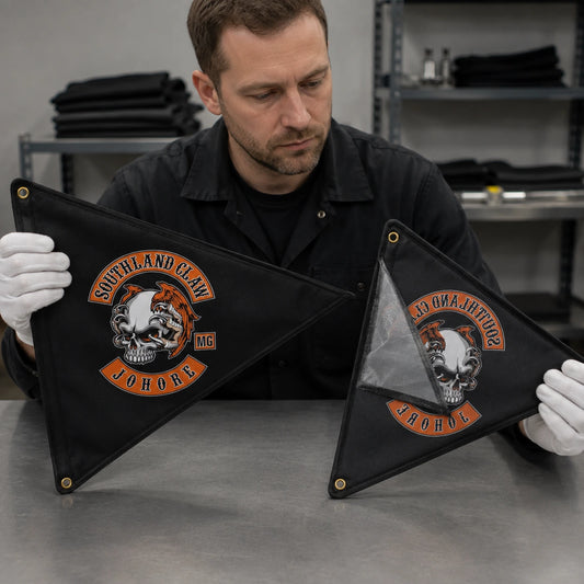 A product inspector compares single-sided and double-sided motorcycle club triangle flags.