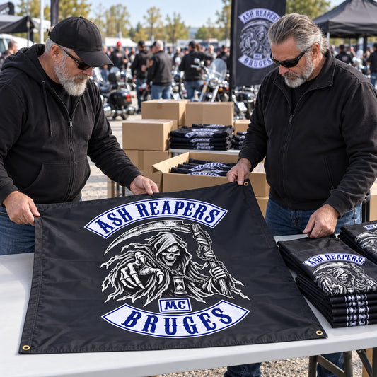 Two rally organizers inspect an Ash Reapers square club flag beside prepared event quantities.