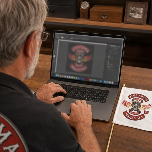 A motorcycle club secretary prepares approved logo artwork beside a small custom square flag reference.