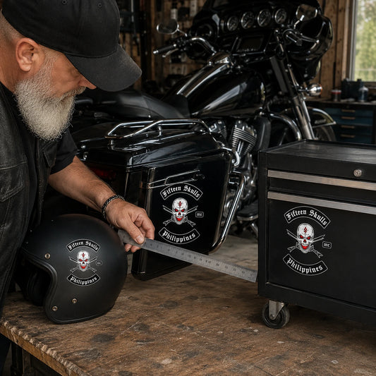 Club quartermaster comparing custom sticker sizes for a helmet, motorcycle pannier and garage toolbox.