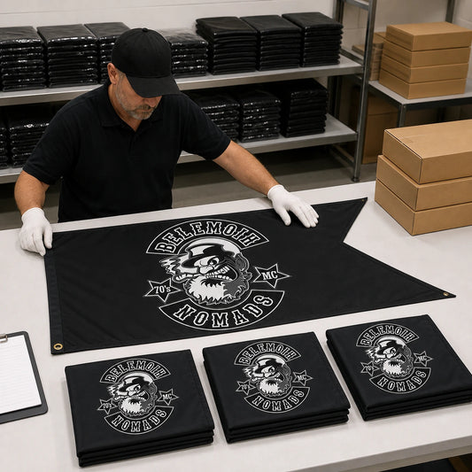 Finished custom motorcycle club swallowtail flags passing final inspection before worldwide shipping.