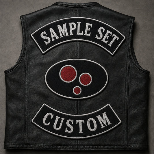 Custom motorcycle club three-piece rocker set with a neutral fictional center emblem on a leather vest.
