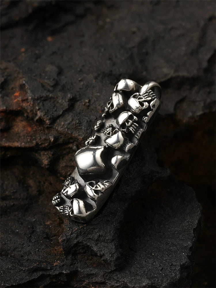 Multi-skull sterling silver biker pendant angled view showing raised skull details
