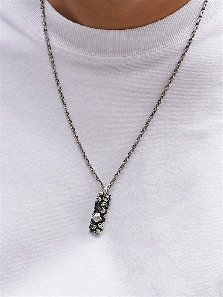 Multi-skull sterling silver biker pendant styled on a chain