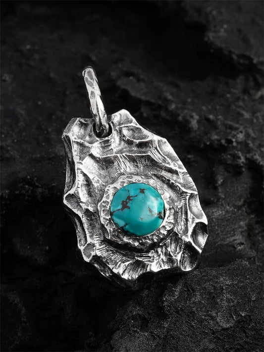 Front view of natural turquoise rock sterling silver biker pendant