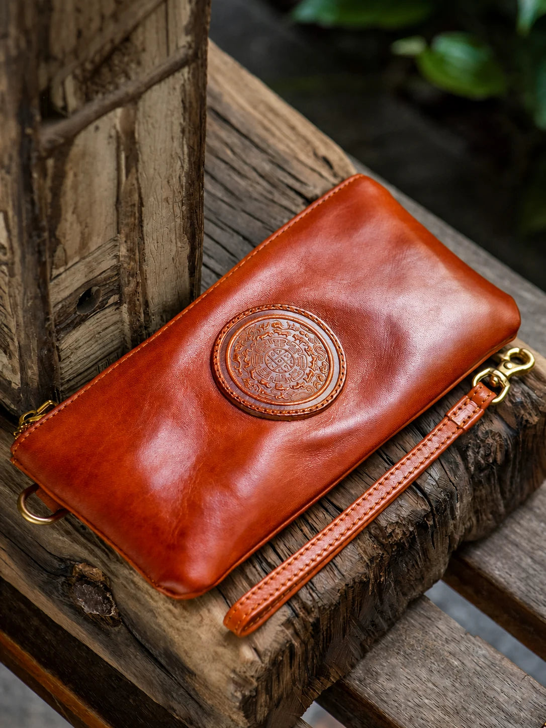 vintage brown leather wristlet wallet on rustic wood