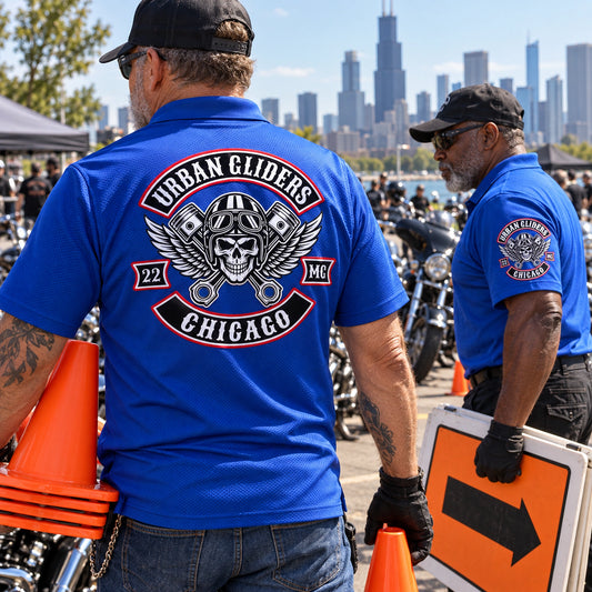 Urban Gliders Chicago event crew wear royal blue performance polos with large back and sleeve club branding during rally setup.