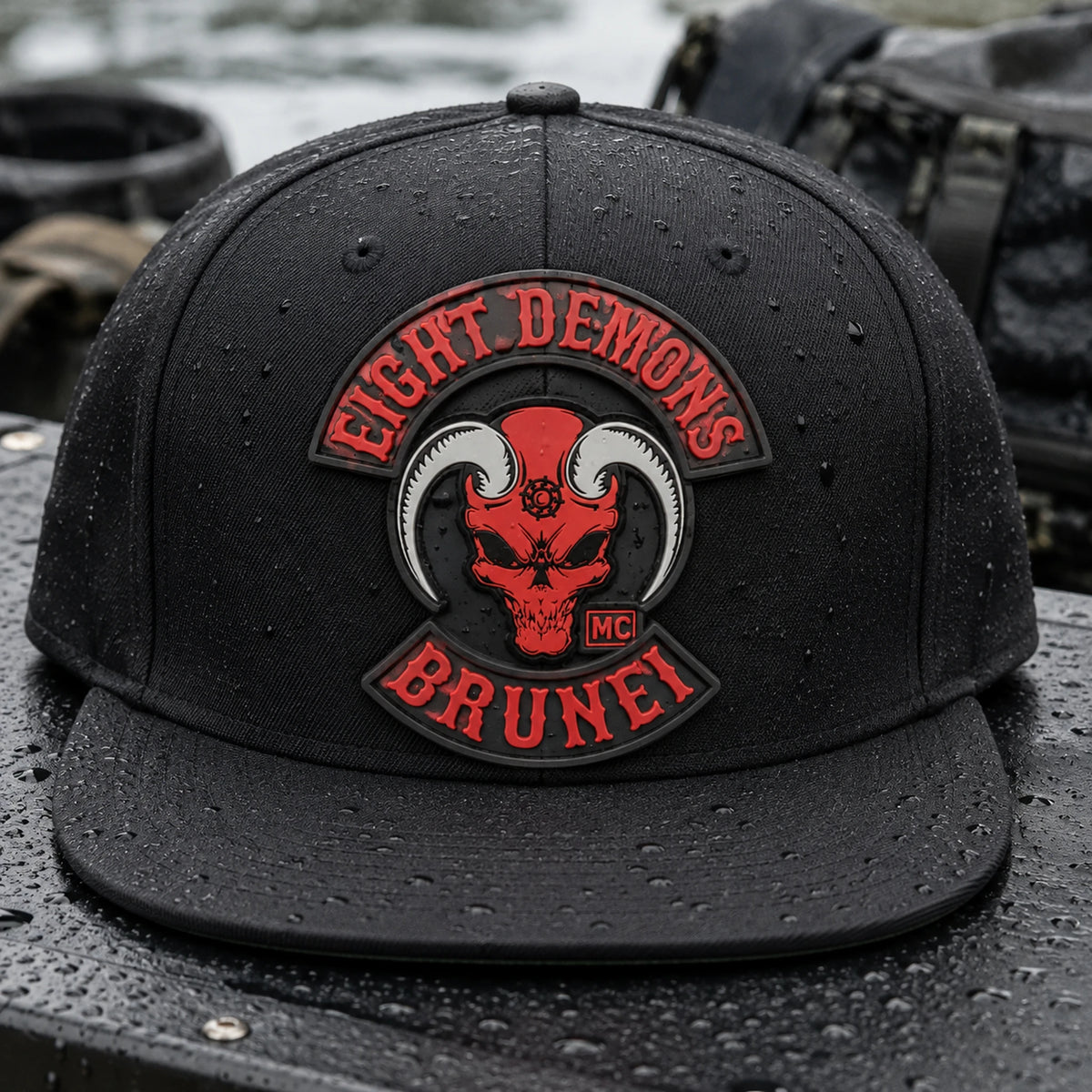 A black motorcycle club flat-brim cap shows a flexible dimensional PVC emblem patch.